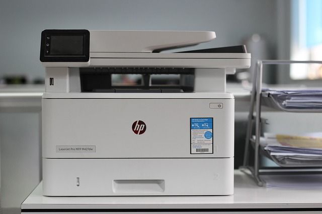 An office printer running out of paper in a modern workplace.