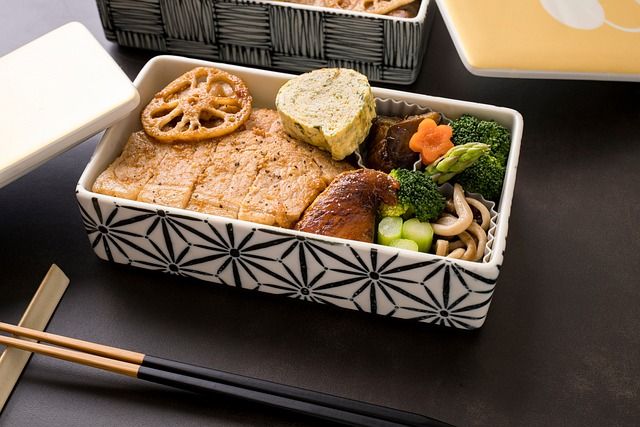 A person preparing a healthy lunchbox for work