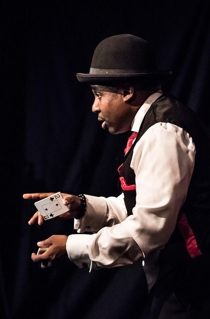 A magician performing a magic trick on stage.