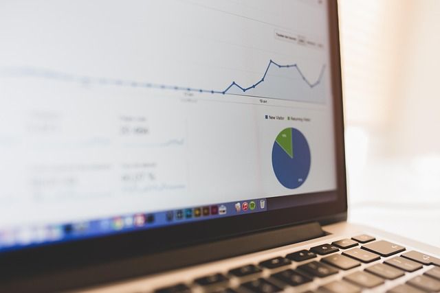 A professional rechecking data on a laptop screen in an office.