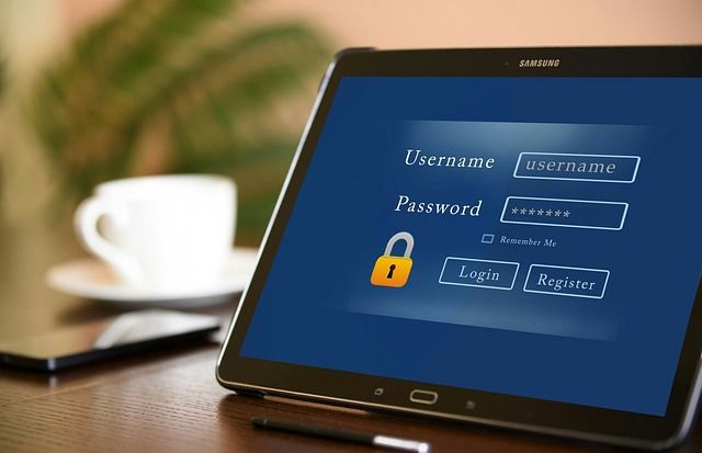 A close-up of someone typing a username on a laptop login screen.