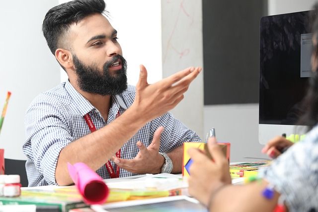 An employee talking with a manager in a modern office.