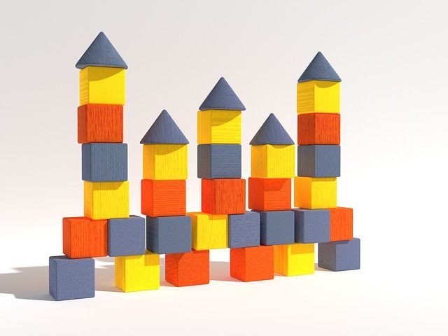 Two toy block towers side by side with one clearly taller than the other.