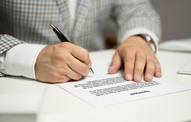Close up of business partners signing a contract.